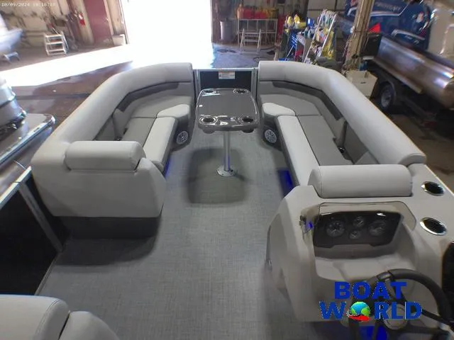 Slide: The Image of 2025 Princecraft Vectra 23 RL pontoon interior with lounge seating and table in a showroom. - 25