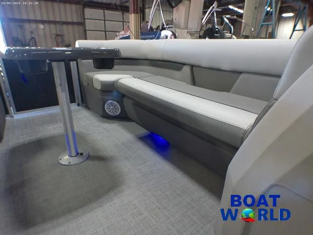 Slide: The Image of 2025 Princecraft Vectra 23 RL pontoon interior with lounge seating and table, in showroom. - 27