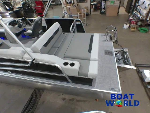 Slide: The Image of 2025 Princecraft Vectra 23 RL pontoon with lounge seating in showroom. - 6