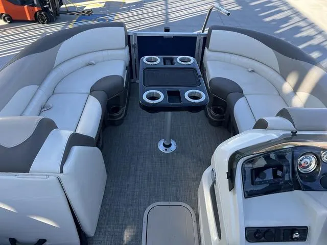 Slide: The Image of 2021 Avalon LSZ Versatile Rear Bench 24 FT pontoon boat interior with seating and table. - 10