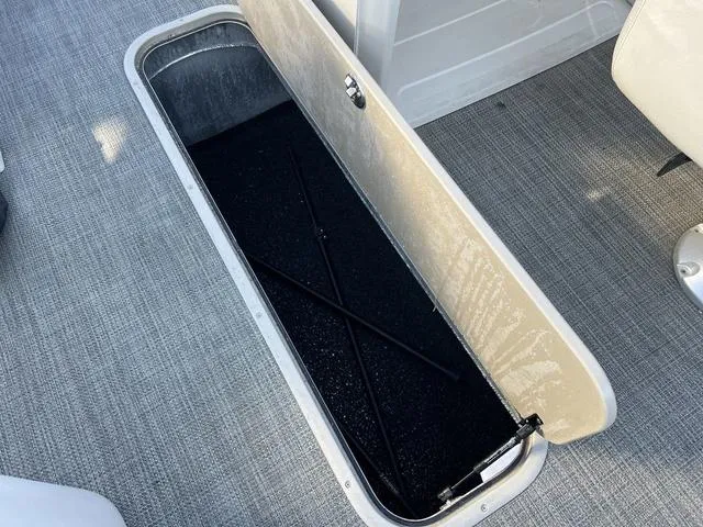 Slide: The Image of Open storage compartment in 2021 Avalon LSZ Versatile Rear Bench boat. - 15