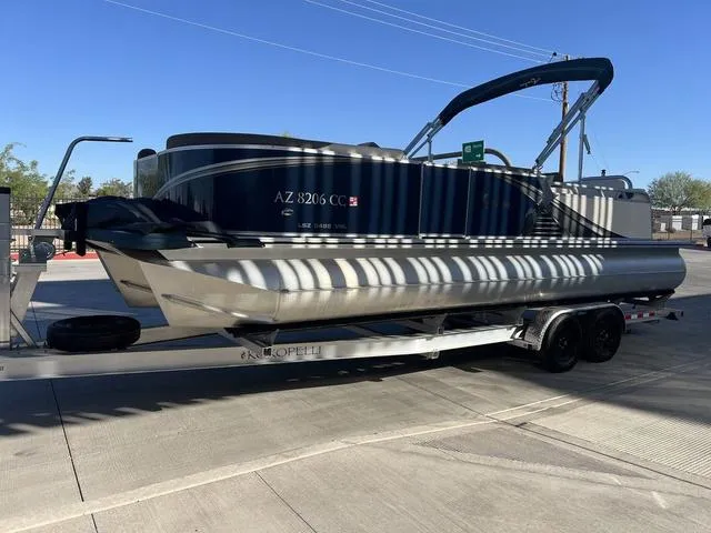 Slide: The Image of 2021 Avalon LSZ Versatile Rear Bench 24 FT pontoon boat on trailer. - 7