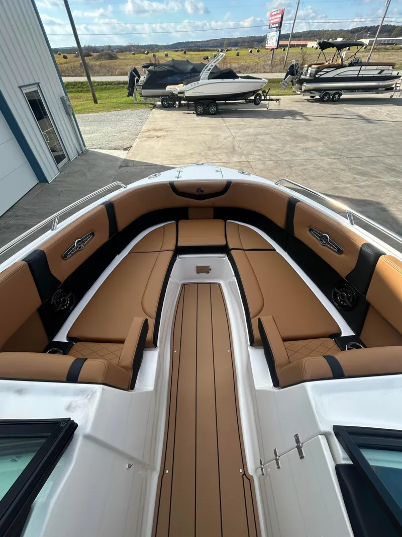 Slide: The Image of 2025 Chaparral 30 Surf boat with tan seating and sleek design. - 10