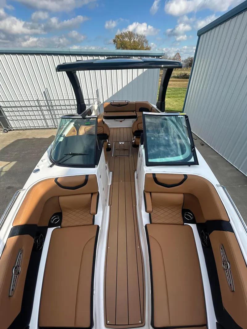Slide: The Image of 2025 Chaparral 30 Surf boat with luxurious tan seating and sleek design. - 11