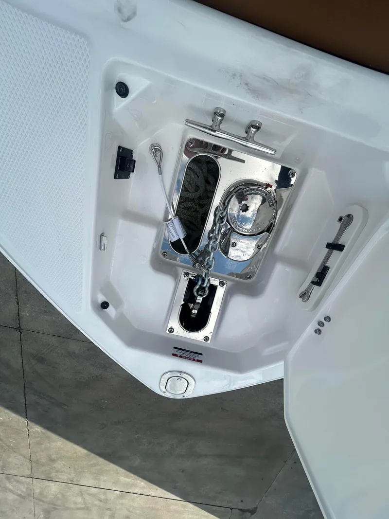 Slide: The Image of 2025 Chaparral 30 Surf boat anchor compartment with stainless steel fittings. - 12