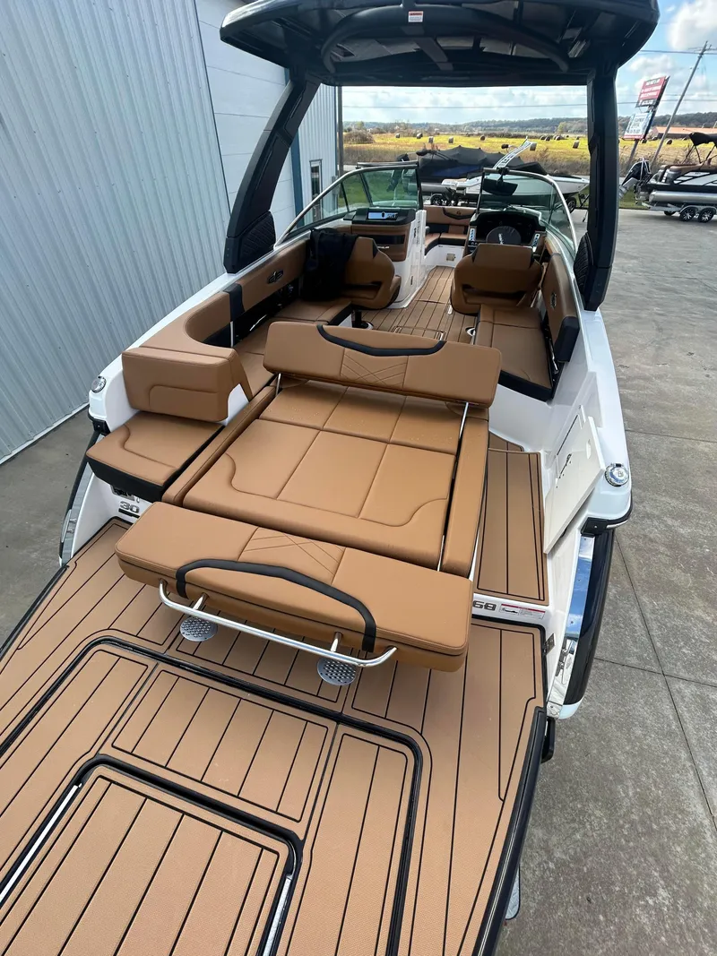 Slide: The Image of 2025 Chaparral 30 Surf boat with luxurious tan seating and spacious deck. - 4