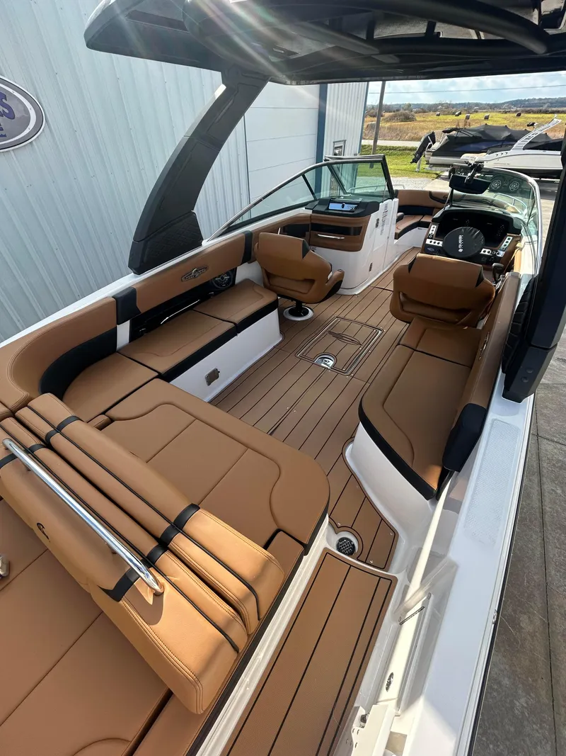 Slide: The Image of 2025 Chaparral 30 Surf boat with luxurious tan seating and sleek design. - 5