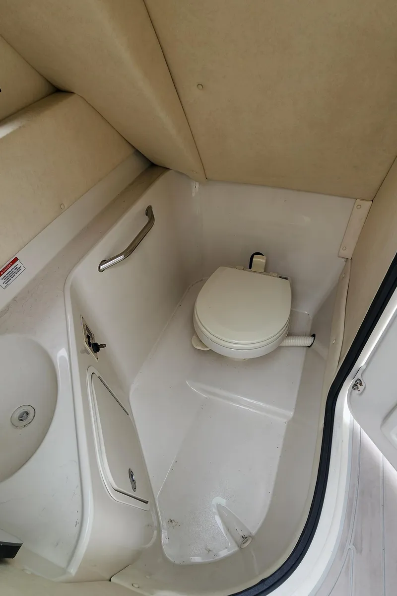 Slide: The Image of 2007 Sea Ray 260 Sundeck boat bathroom interior with compact toilet. - 13