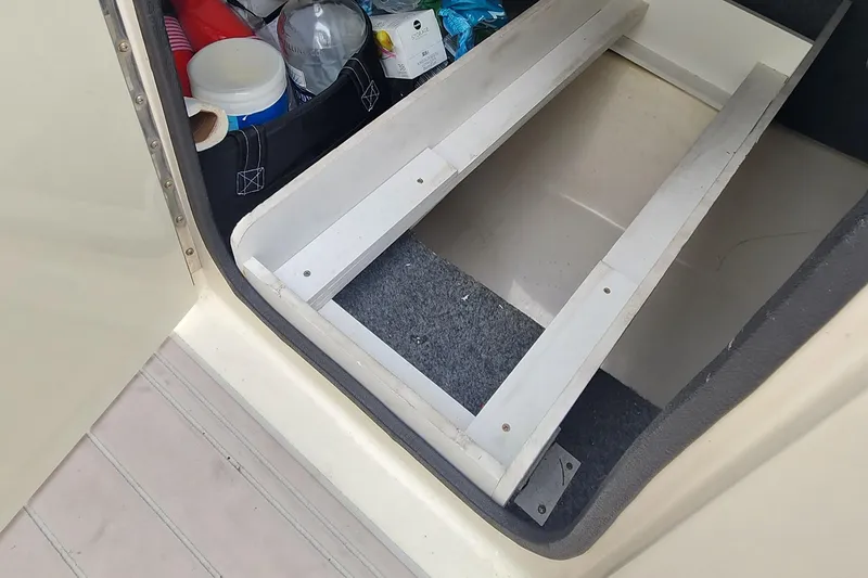 Slide: The Image of Storage compartment in 2007 Sea Ray 260 Sundeck boat with various items. - 14