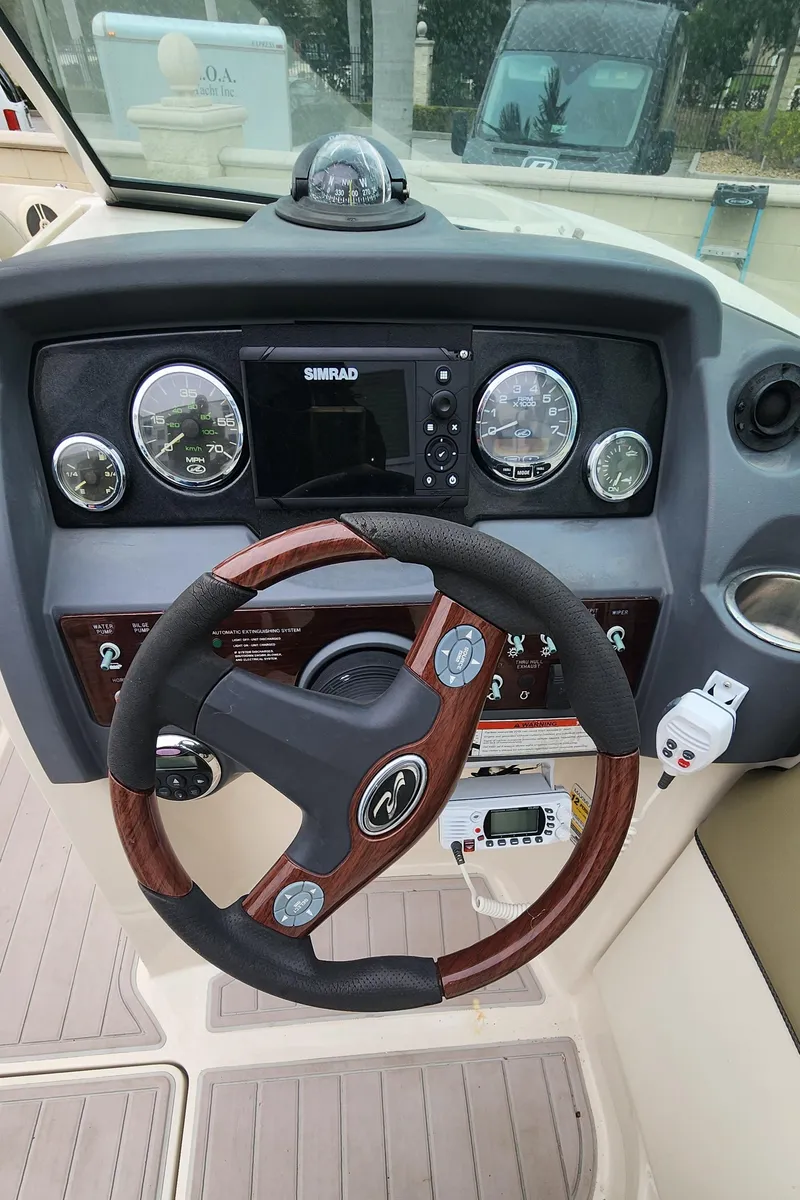 Slide: The Image of 2007 Sea Ray 260 Sundeck dashboard with steering wheel and gauges. - 15