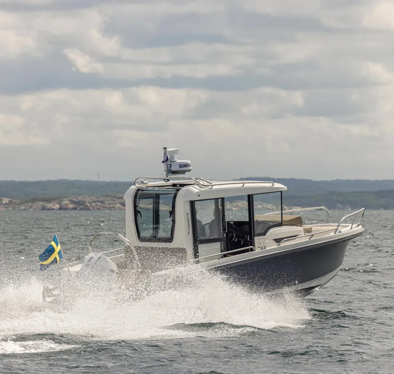 Slide: The Image of Nimbus C8 2025 boat cruising on a choppy sea under cloudy skies. - 2