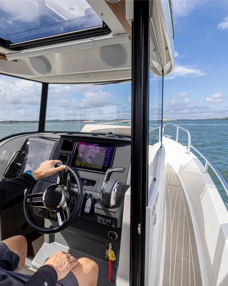 Slide: The Image of 2025 Nimbus C8 boat interior with modern dashboard and ocean view. - 24