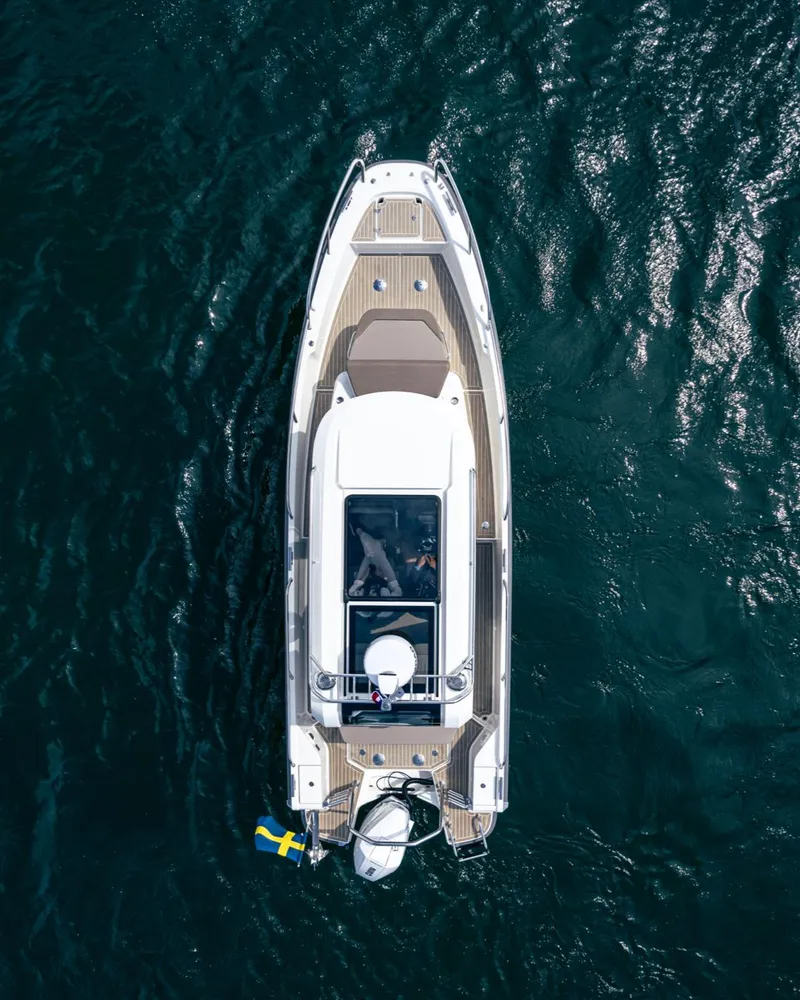 Slide: The Image of Aerial view of 2025 Nimbus C8 boat on open water with Swedish flag. - 28