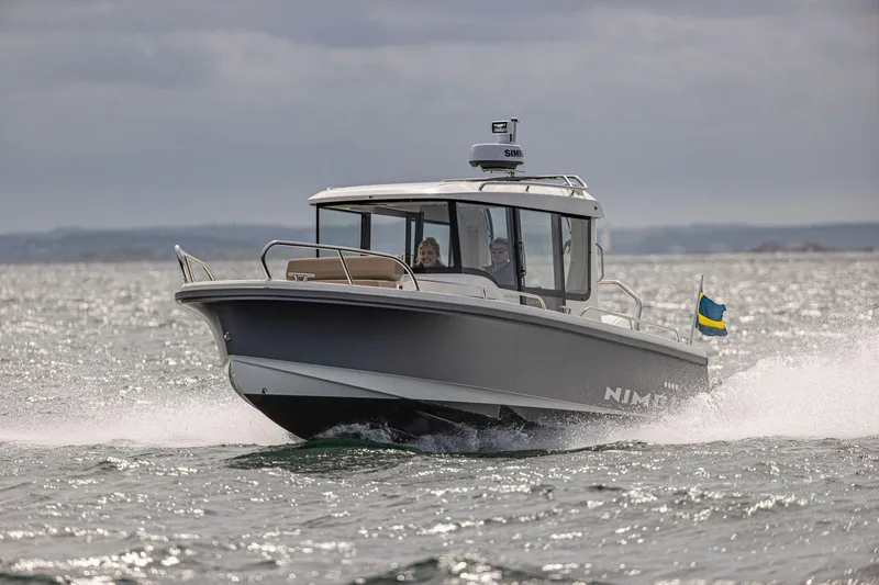 Slide: The Image of 2025 Nimbus C8 boat cruising on open water with Swedish flag. - 30