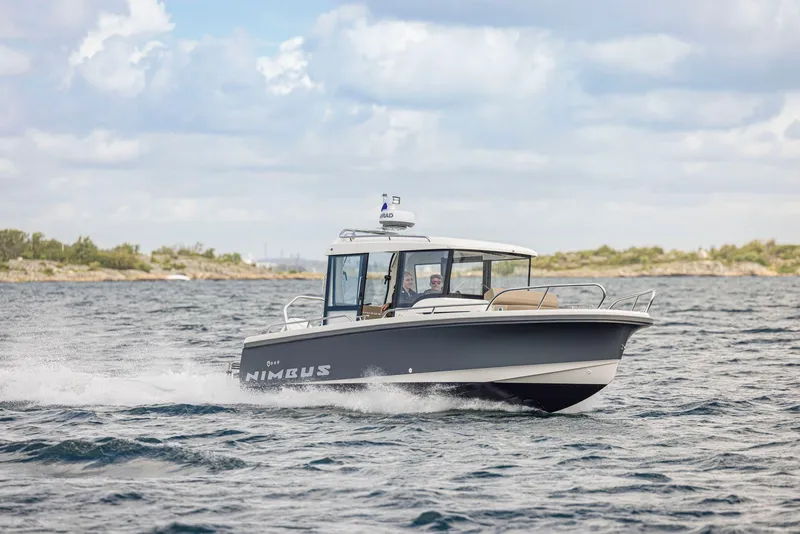 Slide: The Image of Nimbus C8 2025 motorboat cruising on open water under a cloudy sky. - 31