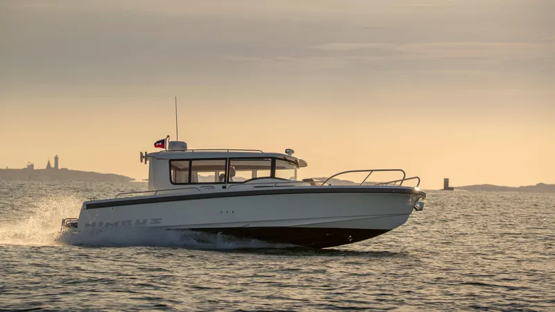 Slide: The Image of Nimbus C9 2025 boat cruising at sunset on open water. - 14
