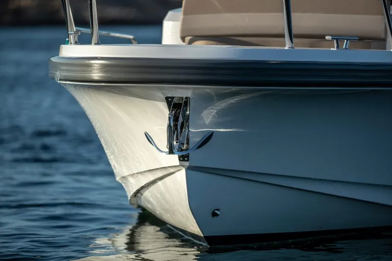 Slide: The Image of 2025 Nimbus C9 boat bow on calm water, sleek design. - 17