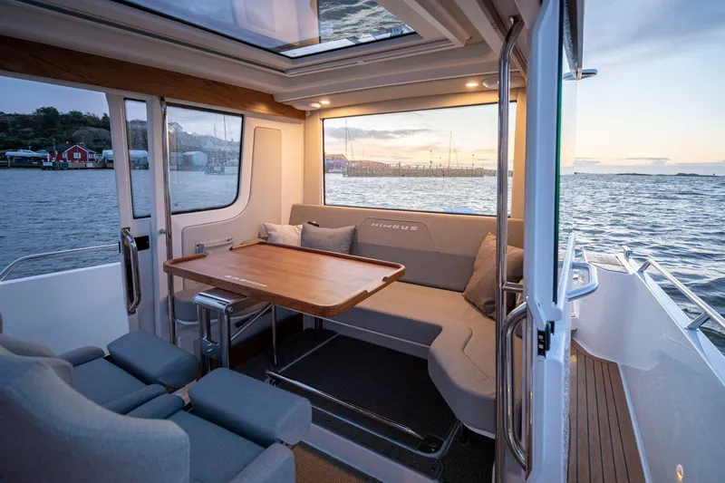 Slide: The Image of Luxurious interior of 2025 Nimbus C9 boat with ocean view and comfortable seating. - 7