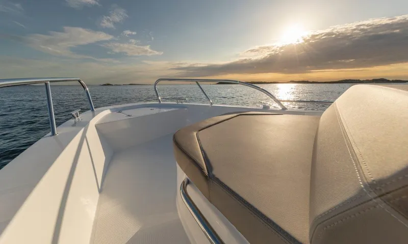 Slide: The Image of Nimbus C9 boat deck at sunset, 2025 model, serene ocean view. - 21