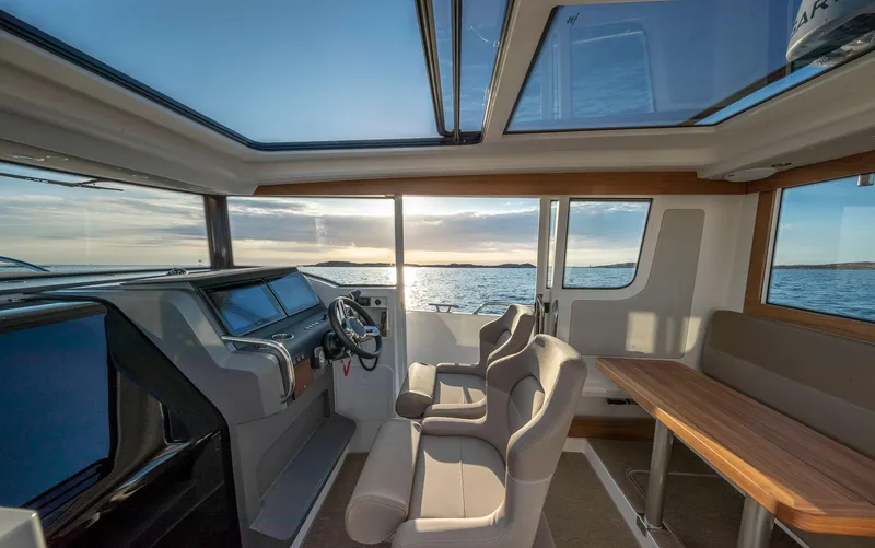 Slide: The Image of Luxurious interior of 2025 Nimbus C9 boat with panoramic windows and modern seating. - 8