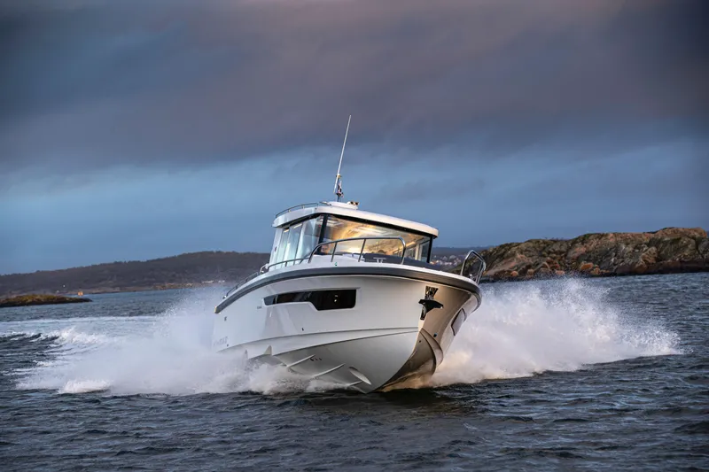 Slide: The Image of Nimbus C11 2025 boat cruising on water with dramatic sky backdrop. - 10