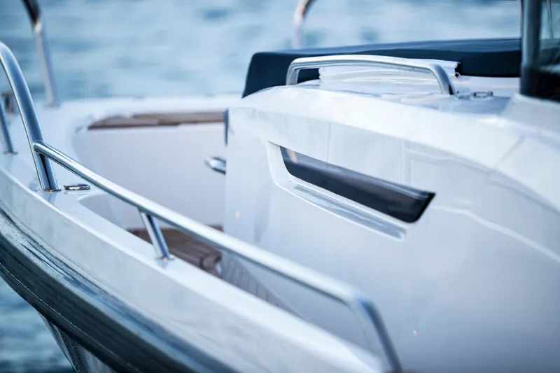 Slide: The Image of Close-up of 2025 Nimbus C11 boat railing and deck, with blurred water background. - 14