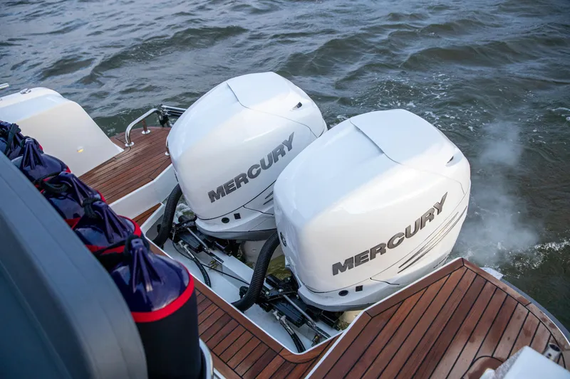 Slide: The Image of Twin Mercury outboard engines on a 2025 Nimbus C11 boat, cruising on water. - 20