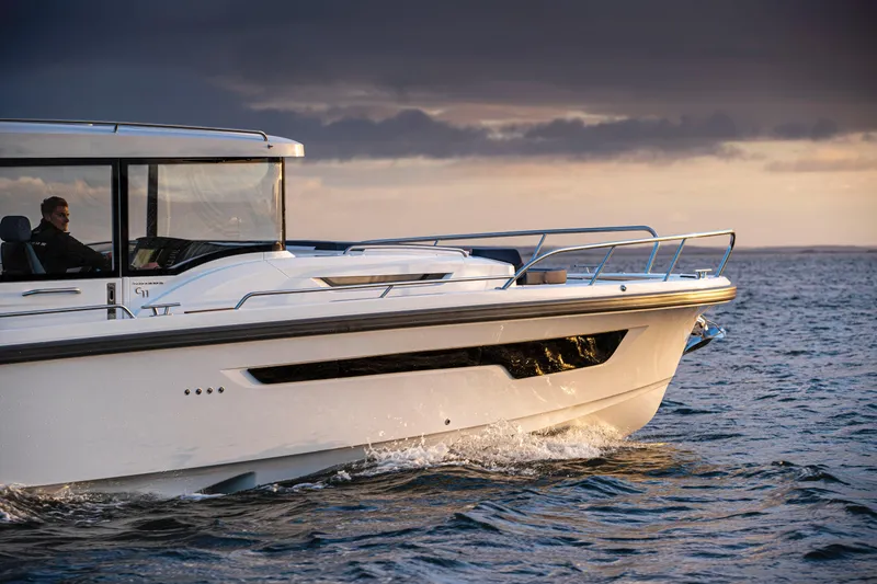 Slide: The Image of Nimbus C11 2025 boat cruising on open water at sunset. - 7