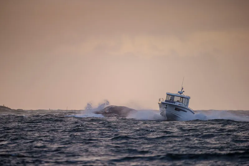 Slide: The Image of Nimbus C11 boat navigating rough seas at sunset, 2025 model. - 15