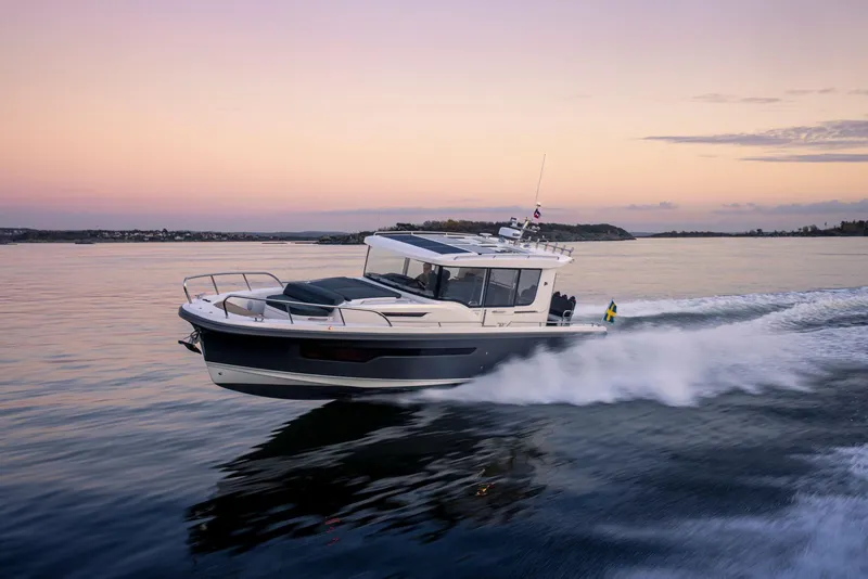 Slide: The Image of Nimbus C11 2025 boat cruising at sunset on calm waters. - 2