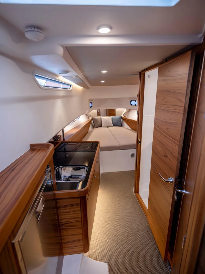 Slide: The Image of Luxurious interior of 2025 Nimbus C11 yacht with modern wood finishes and cozy seating. - 32
