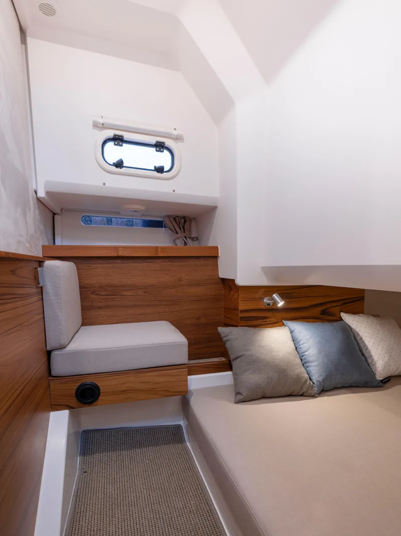 Slide: The Image of Cozy cabin interior of 2025 Nimbus C11 with wooden accents and comfortable bedding. - 36
