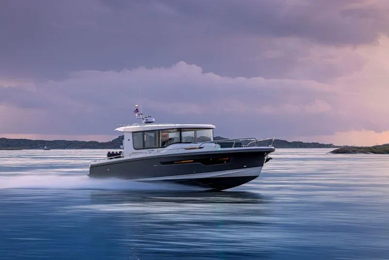Slide: The Image of Nimbus C11 2025 boat cruising on calm waters at sunset. - 5