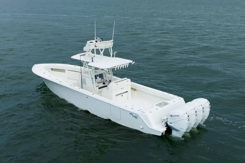 Slide: The Image of 2017 SeaVee 390z Center Console boat on open water, featuring four outboard engines. - 1