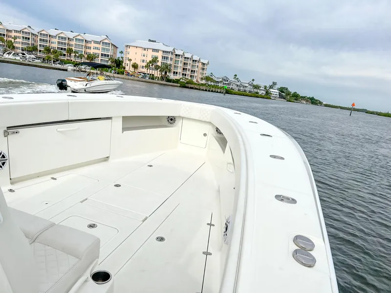 Slide: The Image of 2017 SeaVee 390z Center Console boat on calm water near waterfront buildings. - 10
