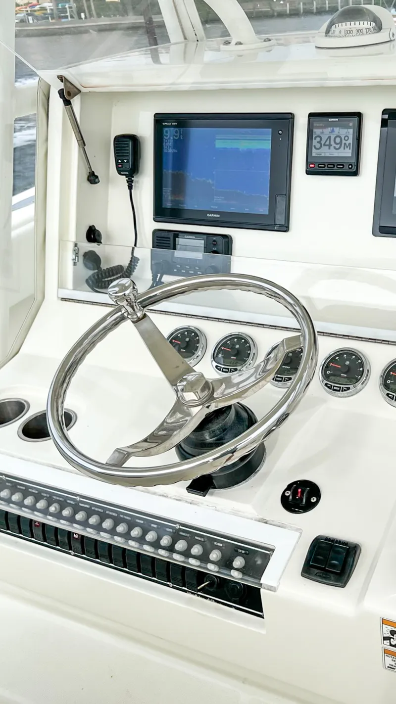 Slide: The Image of 2017 SeaVee 390z Center Console helm with modern navigation instruments and steering wheel. - 12