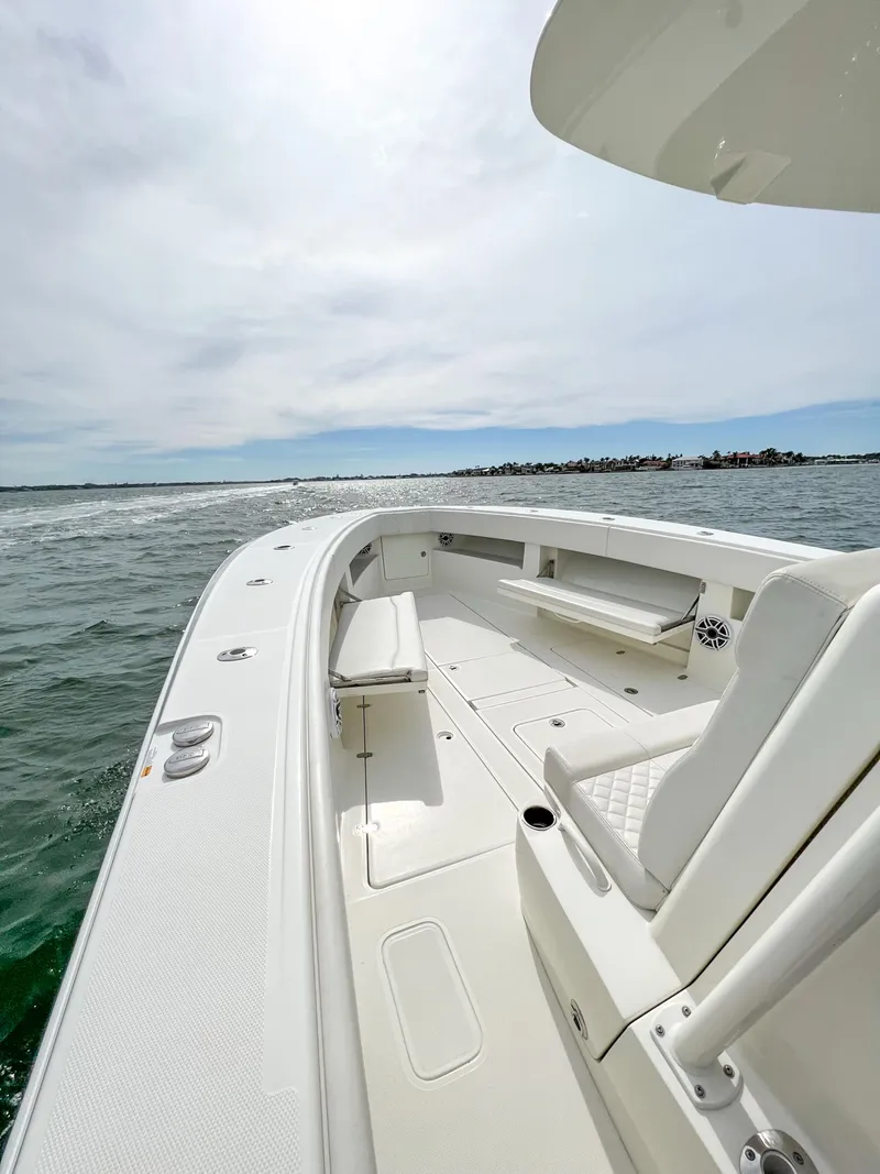 Slide: The Image of 2017 SeaVee 390z Center Console boat on open water, showcasing sleek design and spacious deck. - 20