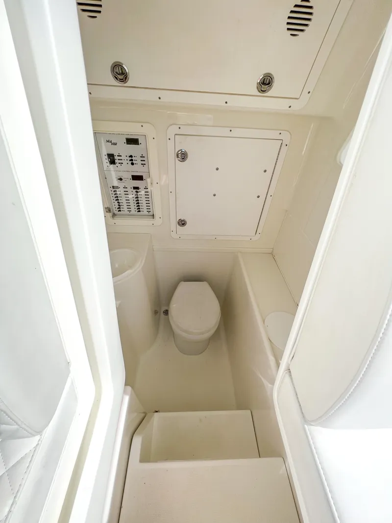 Slide: The Image of 2017 SeaVee 390z Center Console boat interior with toilet and control panel. - 21