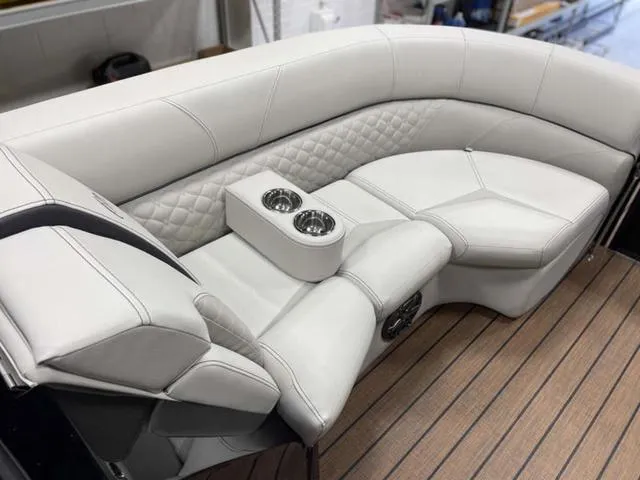Slide: The Image of Luxurious seating on 2024 Manitou 25 LX SHP DE boat with dual cup holders. - 15