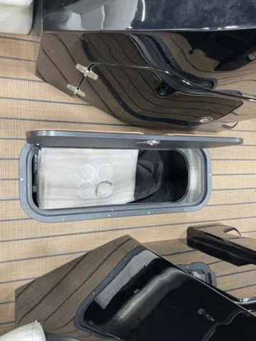 Slide: The Image of 2024 Manitou 25 LX SHP DE boat storage compartment on deck. - 17