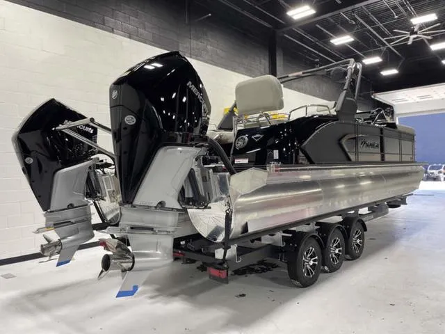 Slide: The Image of 2024 Manitou 25 LX SHP DE dual-engine boat in showroom, rear view. - 3