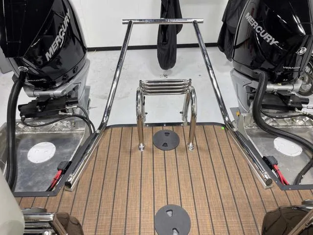 Slide: The Image of 2024 Manitou 25 LX SHP DE boat with dual Mercury engines and teak deck. - 5