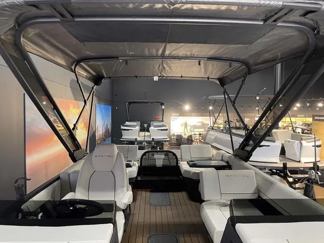 Slide: The Image of 2024 Manitou EXPLORE 24 MAX SGP DUAL ENGINE luxury boat interior with seating and canopy. - 13