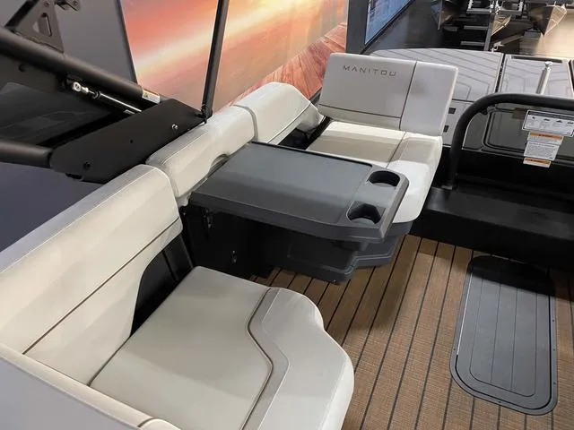 Slide: The Image of 2024 Manitou EXPLORE 24 MAX SGP boat interior with seating and table. - 16