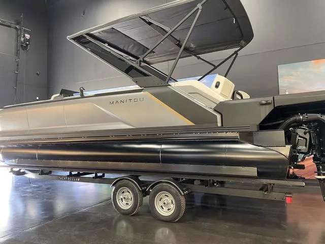 Slide: The Image of 2024 Manitou EXPLORE 24 MAX SGP dual engine pontoon boat on trailer. - 3