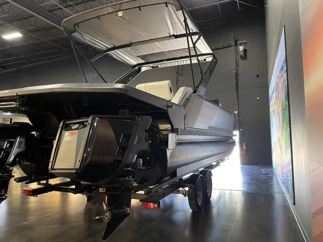 Slide: The Image of 2024 Manitou EXPLORE 24 MAX SGP dual engine boat in showroom. - 6