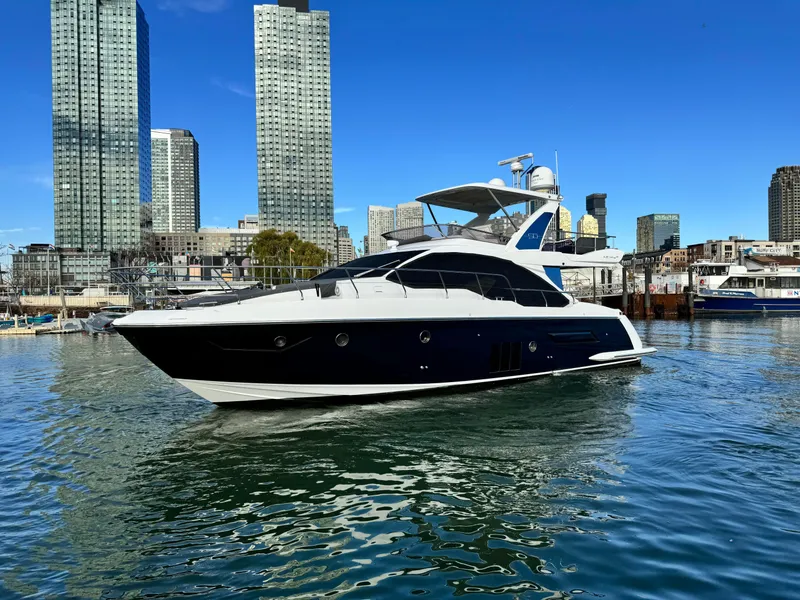 Slide: The Image of Azimut 50 Flybridge 2016 yacht in urban marina with skyscrapers in background. - 17