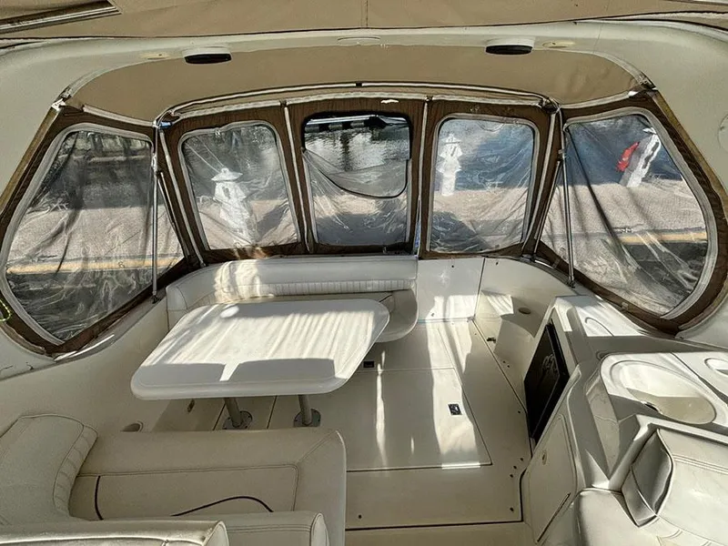 Slide: The Image of Interior of 2000 Cruisers Yachts 3375 Express with seating and table, enclosed by clear panels. - 10