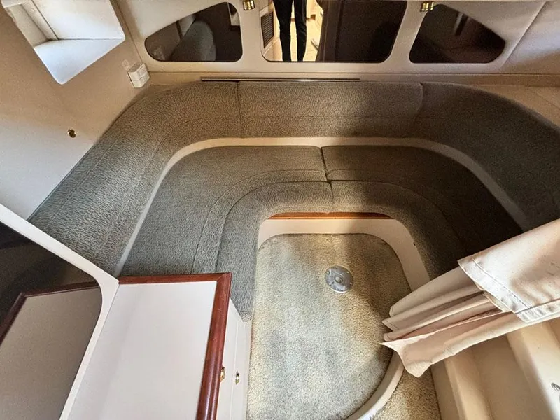 Slide: The Image of Interior cabin of 2000 Cruisers Yachts 3375 Express with cozy seating and carpeted flooring. - 19