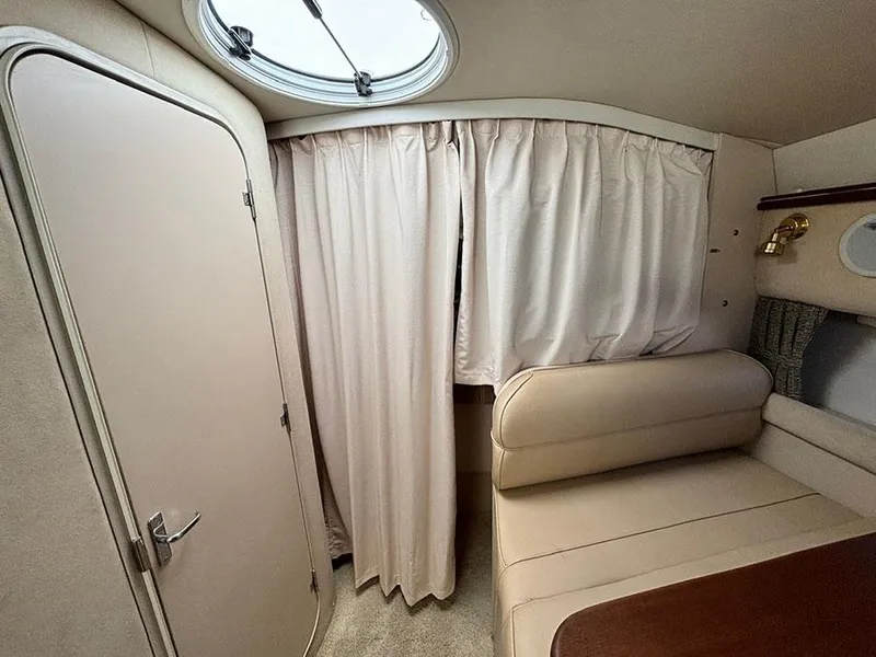 Slide: The Image of Interior cabin of 2000 Cruisers Yachts 3375 Express with beige seating and curtains. - 23